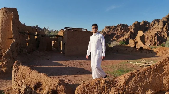 Saudi Man in Thobe at Ancient Mud Village Ruins