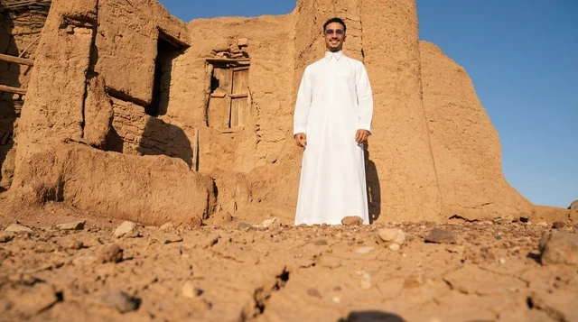 Saudi Man in Thobe at Ancient Mud Ruins