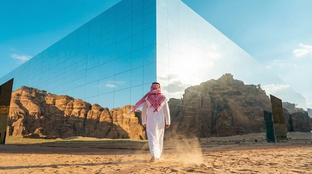 Saudi Man at Maraya AlUla Building with Desert Reflection