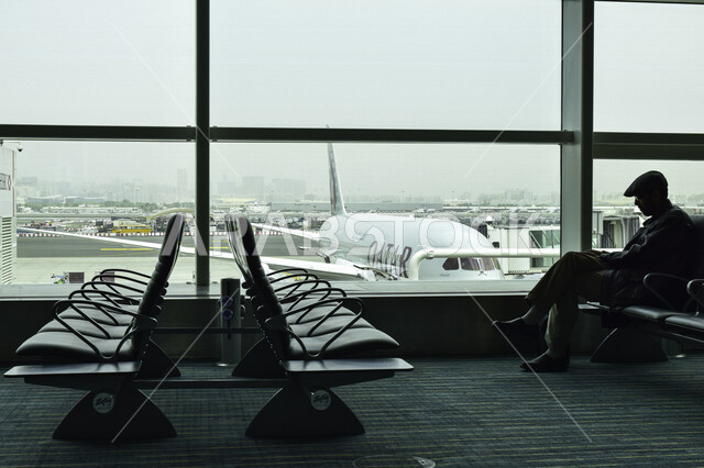 صورة لمسافر عربي خليجي ينتظر رحلته في قاعة الانتظار في مطار حمد الدولي بمدينة الدوحة، قاعة انتظار المسافرين ، رحلة جوية سياحية ، رحلة عمل ،سياحة وسفر 