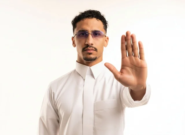 Saudi Man in Thobe Making Stop Gesture Portrait