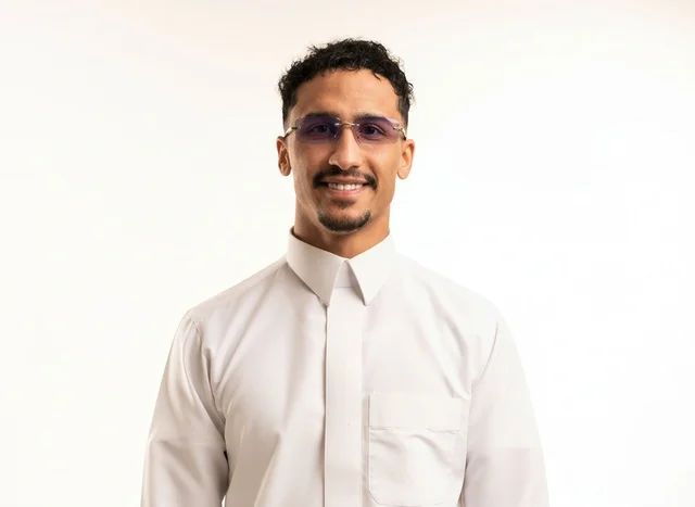 Saudi Man in Traditional White Thobe and Glasses