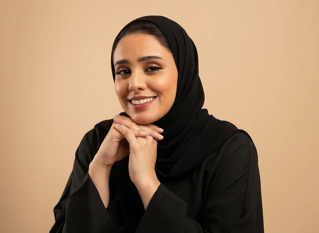 امرأة سعودية بالعباءة السوداء على خلفية بيج