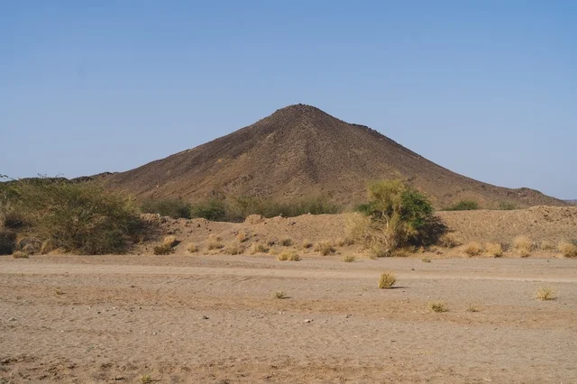 Rocky Mountain in Dry Sandy Desert Landscape
