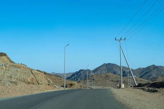 Empty Asphalt Highway in Desert Mountain Landscape