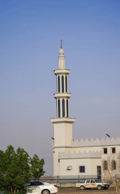 White Mosque Minaret and Tower Against Clear Blue Sky