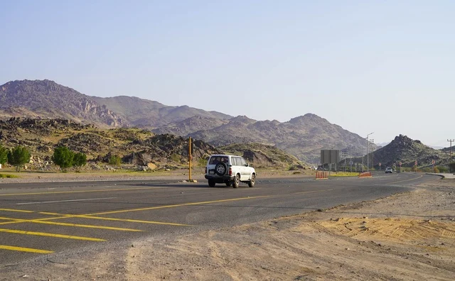 White SUV Driving on Mountain Road in Saudi Arabia