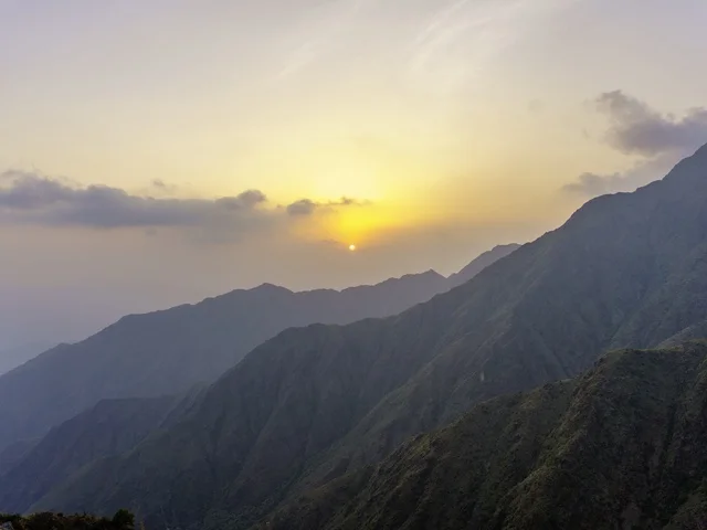 Misty Mountain Range at Sunset with Golden Light