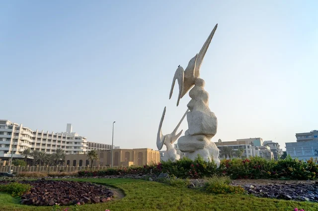 White Bird Sculpture in Urban Park Roundabout City Landmark