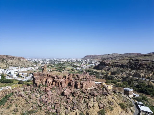 Aerial View of Rocky Hill and Ancient Ruins under Blue Sky
