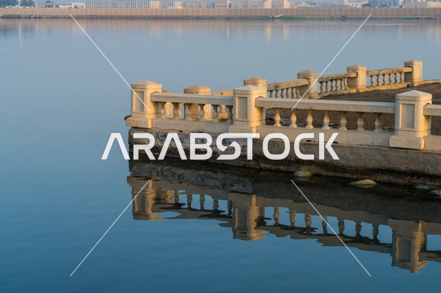 Waterfront Stone Balustrade with Reflection in Calm Water
