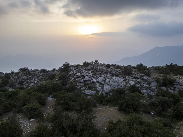 Rocky Mountain Landscape at Sunset under Cloudy Sky