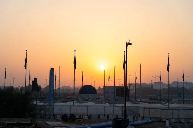 Saudi City Skyline and Flags at Golden Hour Sunset