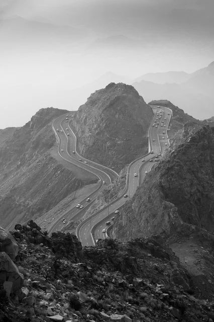 The winding road of Al-Hada Mountain in Taif in black and white.