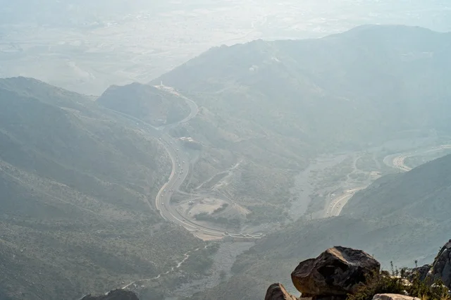 Winding Mountain Road Pass in Misty Valley Aerial View