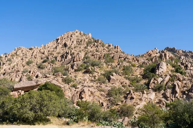 Rocky Mountain Slope Under Clear Blue Sky Desert Landscape