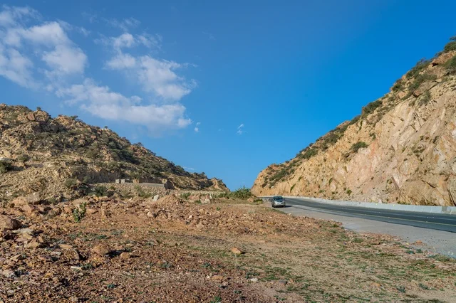 A deserted asphalt mountain road in the Kingdom of Saudi Arabia.