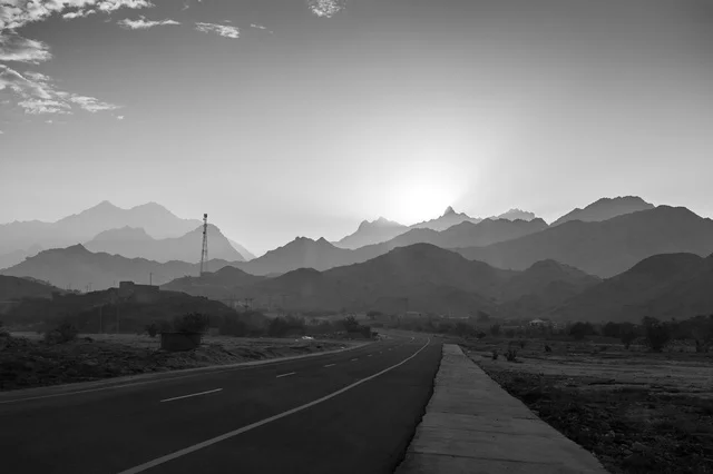 Monochrome Asphalt Road in Mountainous Desert Landscape