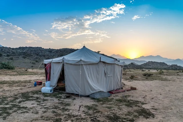 Traditional Camping Tent in Desert Mountain Sunset