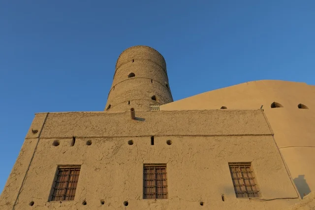 Ancient Bahla Fort Clay Tower Under Blue Sky Oman