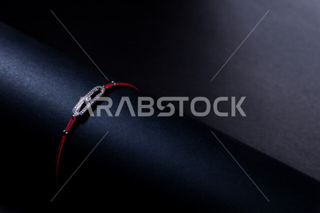 Close-up of a bracelet placed on the hand depicted on a black background, jewelry, accessories, professional photography