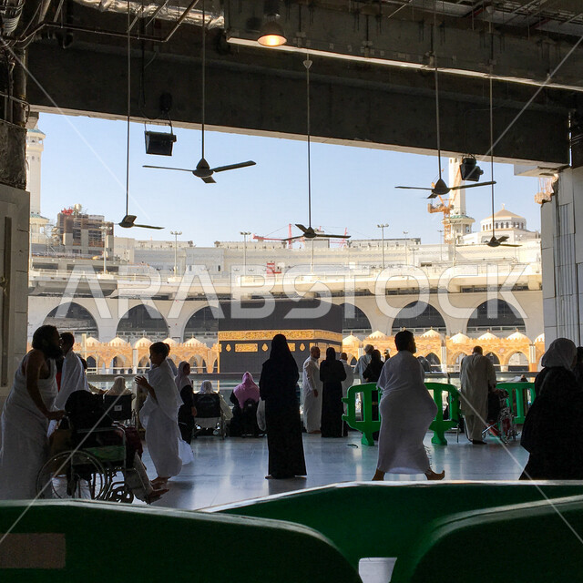 A picture of pilgrims and Umrah performers inside the Great Mosque of Mecca in Makkah Al-Mukarramah, the obligation of Hajj, performing Umrah, circumambulating the Kaaba, Islamic landmarks in the Kingdom of Saudi Arabia, Islamism and worship.