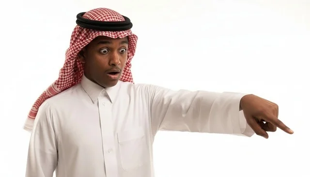 Surprised Saudi Arab Man Pointing on White Background