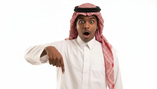 Surprised Saudi Man Pointing Down on White Background