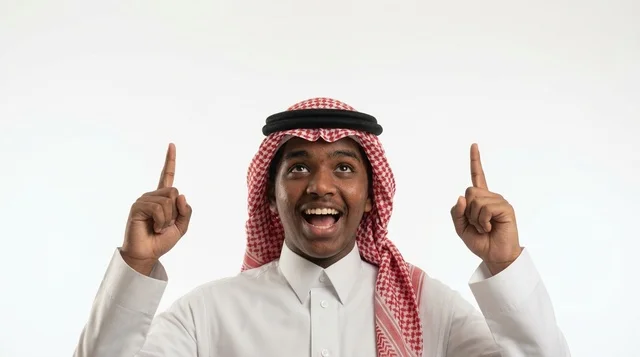Excited Young Saudi Man Pointing Up on White Background