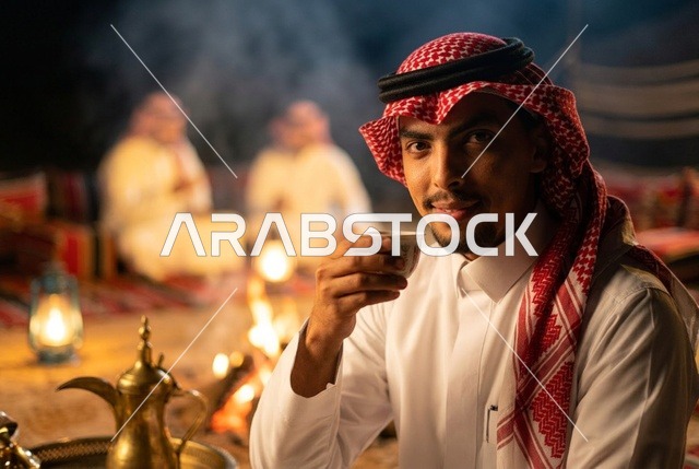 رجل سعودي يشرب القهوة العربية في مخيم صحراوي
