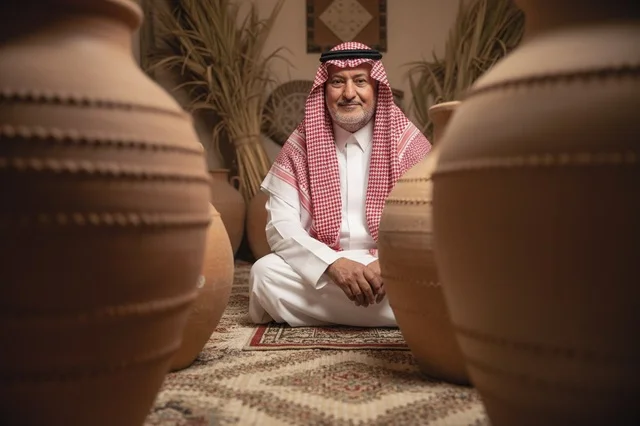 Saudi Elderly Man in Traditional Attire with Clay Pottery