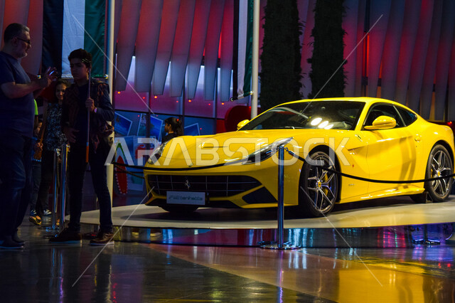A yellow Ferrari berlinetta on display inside Yas Mall, Abu Dhabi, UAE, Ferrari berlinetta, luxury car, Yas Mall for shopping and entertainment, tourism in UAE