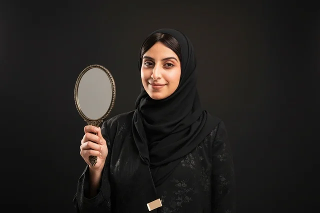 Saudi Woman in Hijab Holding Ornate Hand Mirror in Studio