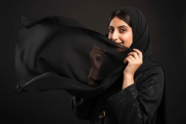 Arab Woman in Black Abaya Holding Flowing Hijab Veil