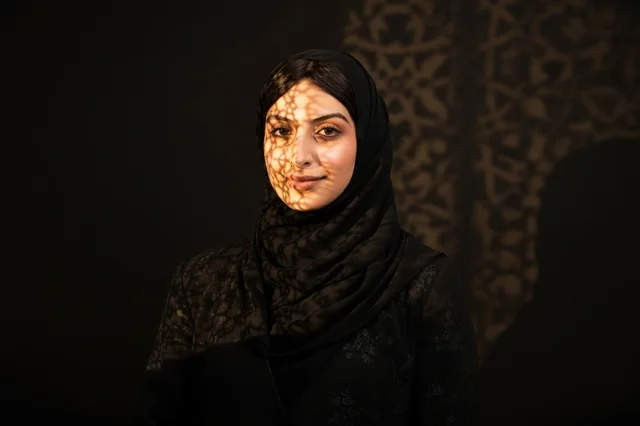 Arab Woman in Black Hijab with Islamic Pattern Shadow
