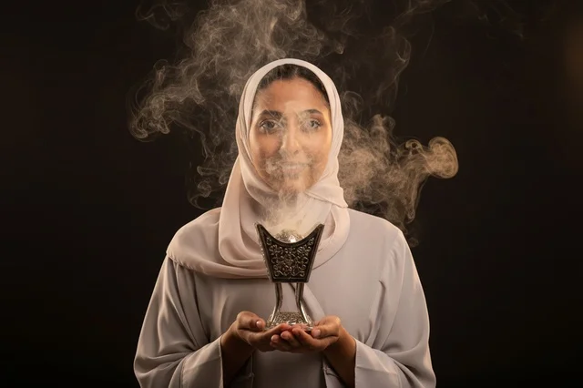 Arab Woman Holding Traditional Incense Burner with Smoke