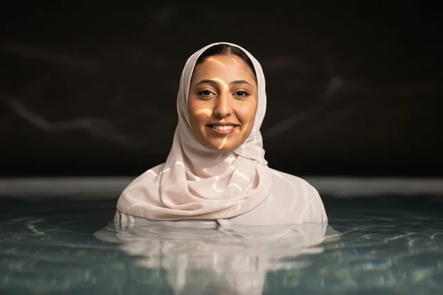 Smiling Muslim Woman in Hijab Swimming Pool Portrait