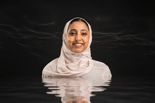 Arab Woman in Hijab Submerged in Dark Water Portrait