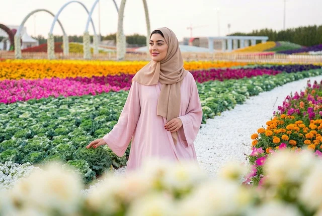 Arab Woman in Pink Abaya at Colorful Flower Garden