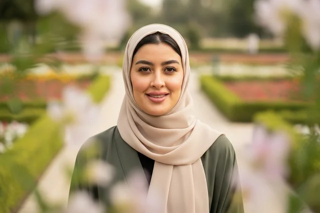 Smiling Arab Woman wearing Hijab in Green Garden Portrait