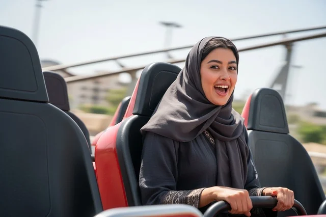 Excited Arab Woman on Theme Park Roller Coaster Ride
