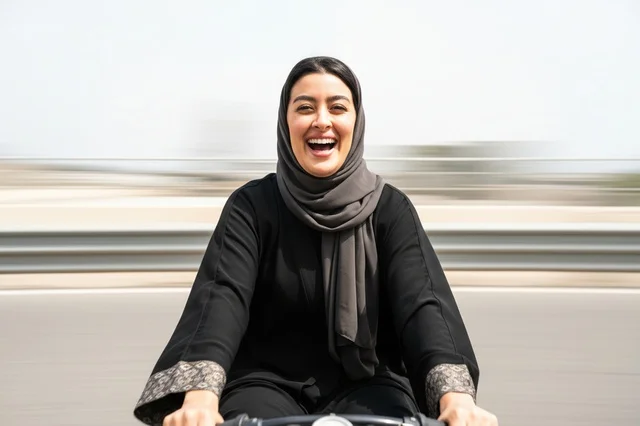Saudi Woman Riding Bicycle with Motion Blur Outdoors