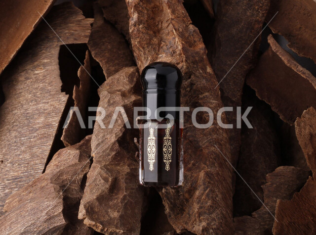 صورة لتولة العود بخلفية خشب العود الطبيعي الفاخر , أجود أنواع العود في المملكة العربية السعودية .