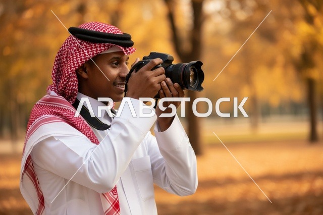 مصور سعودي بكاميرا احترافية في حديقة خريفية ذهبية