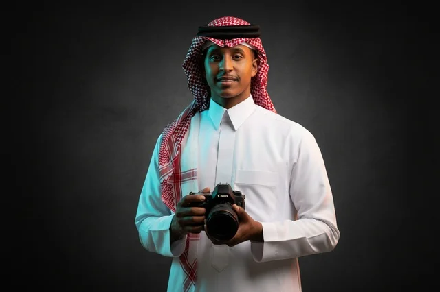 Saudi Man in Traditional Thobe Holding Studio Camera