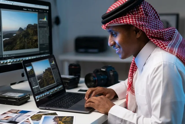 Saudi Photographer Editing Photos on Laptop in Studio