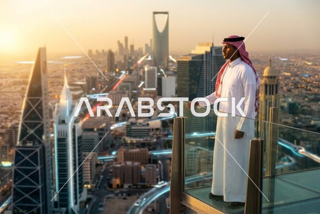 Saudi Man Looking at Riyadh Skyline at Sunset