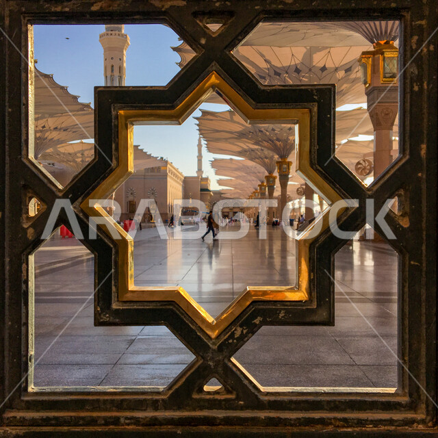 A close to a window inside the civilian campus in Madinah, Islamic architecture, religious parameters in Saudi Arabia, electronic umbrellas in the Prophet's Mosque in Madinah, worship and closer to God, Hajj and Umrah season, Haram al-Nabawi