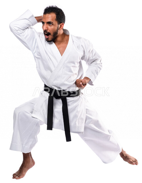 Portrait of a Saudi Arabian Gulf man practicing Japanese karate, white karate uniform with black belt, training in special combat movements, Japanese martial arts, martial arts, physical strength, application of kata movements, white background, full-leng