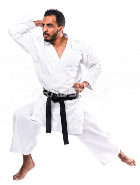 Portrait of a Saudi Arabian Gulf man practicing Japanese karate, white karate uniform with black belt, training in special combat movements, Japanese martial arts, martial arts, physical strength, application of kata movements, white background, full-leng